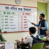 শিক্ষক ব্ল্যাকবোর্ডে আ দিয়ে শব্দের উচ্চারণরীতি শেখাচ্ছেন